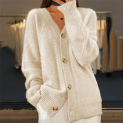 Cream knitted cardigan with gold buttons close-up