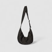 Black shoulder bag with adjustable strap, front view