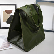 Green slouchy tote with large exterior pockets, side view on table