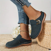 Navy perforated clogs with gold buckle side profile