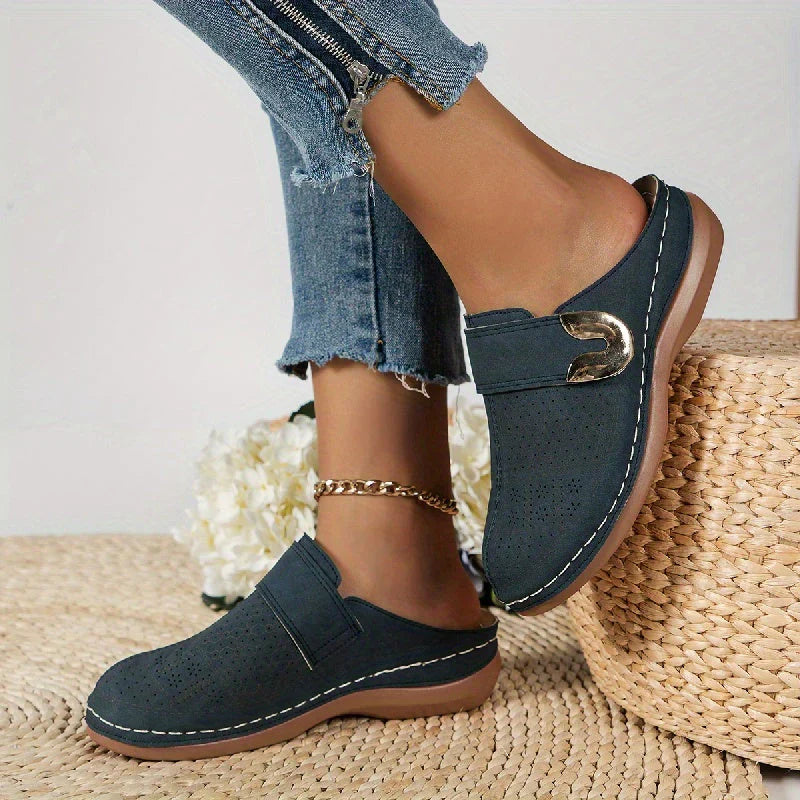 Navy perforated clogs with gold buckle side profile