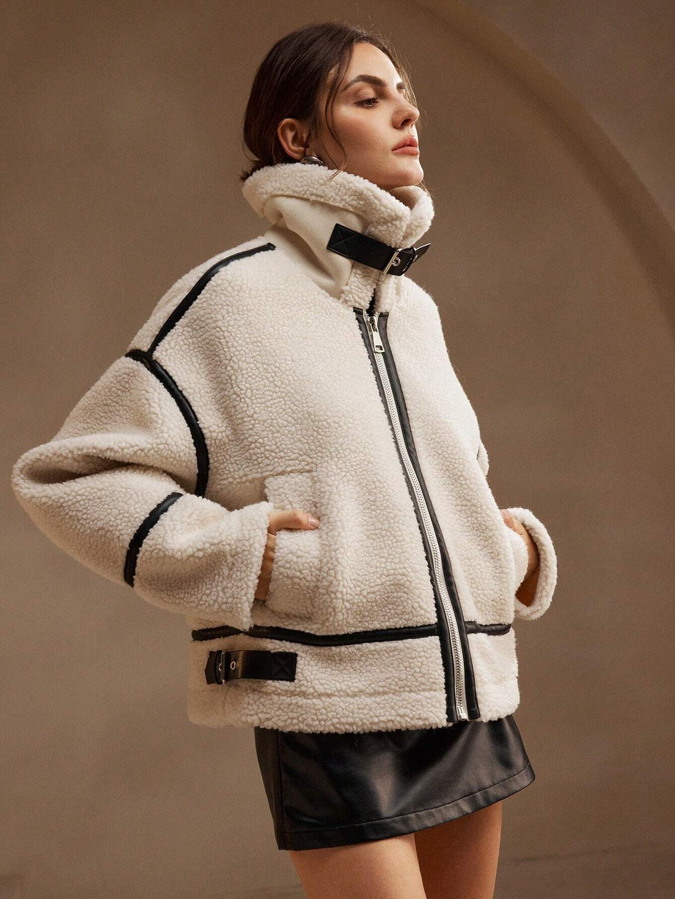 Cream fleece jacket with black trim upper body close-up