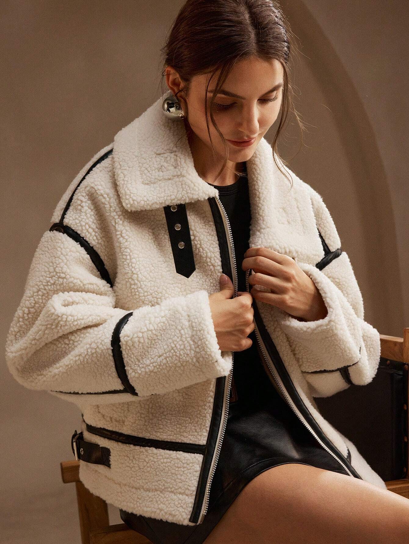 Cream fleece jacket with black trim close-up front view