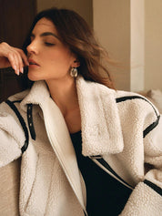 Cream fleece jacket with black trim close-up upper body