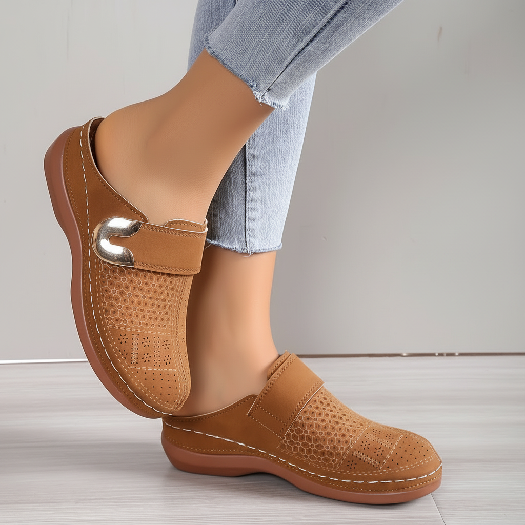 Brown perforated clogs with gold buckle front view