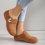 Brown perforated clogs with gold buckle front view