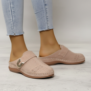 Beige perforated clogs with gold buckle front view