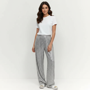 Silver sequin pants worn with white t-shirt and sneakers, front view