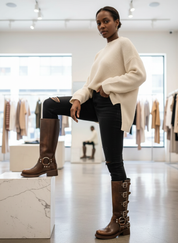 Brown leather biker boots with buckles, front view on model