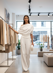 White jumpsuit with draped shoulder and wide legs, front view