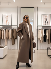 Tan wool blend overcoat front view with white turtleneck and black boots