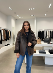 Brown teddy-lined coat front view with blue jeans