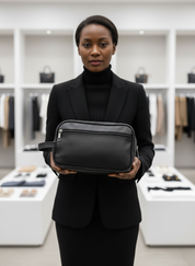 Woman holding black textured toiletry bag front view