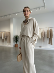 Beige linen jumpsuit with drawstring waist front view