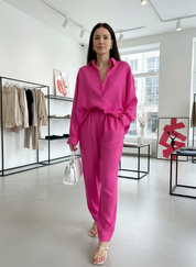 Pink linen jumpsuit with drawstring waist front view