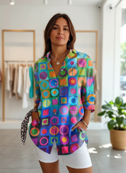 Women's colorful geometric print shirt with rolled sleeves, front view.
