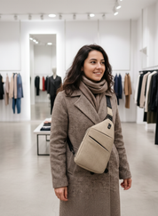 Model wearing beige anti-theft sling bag side view
