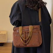 Brown corduroy shoulder bag with multiple pockets, front view