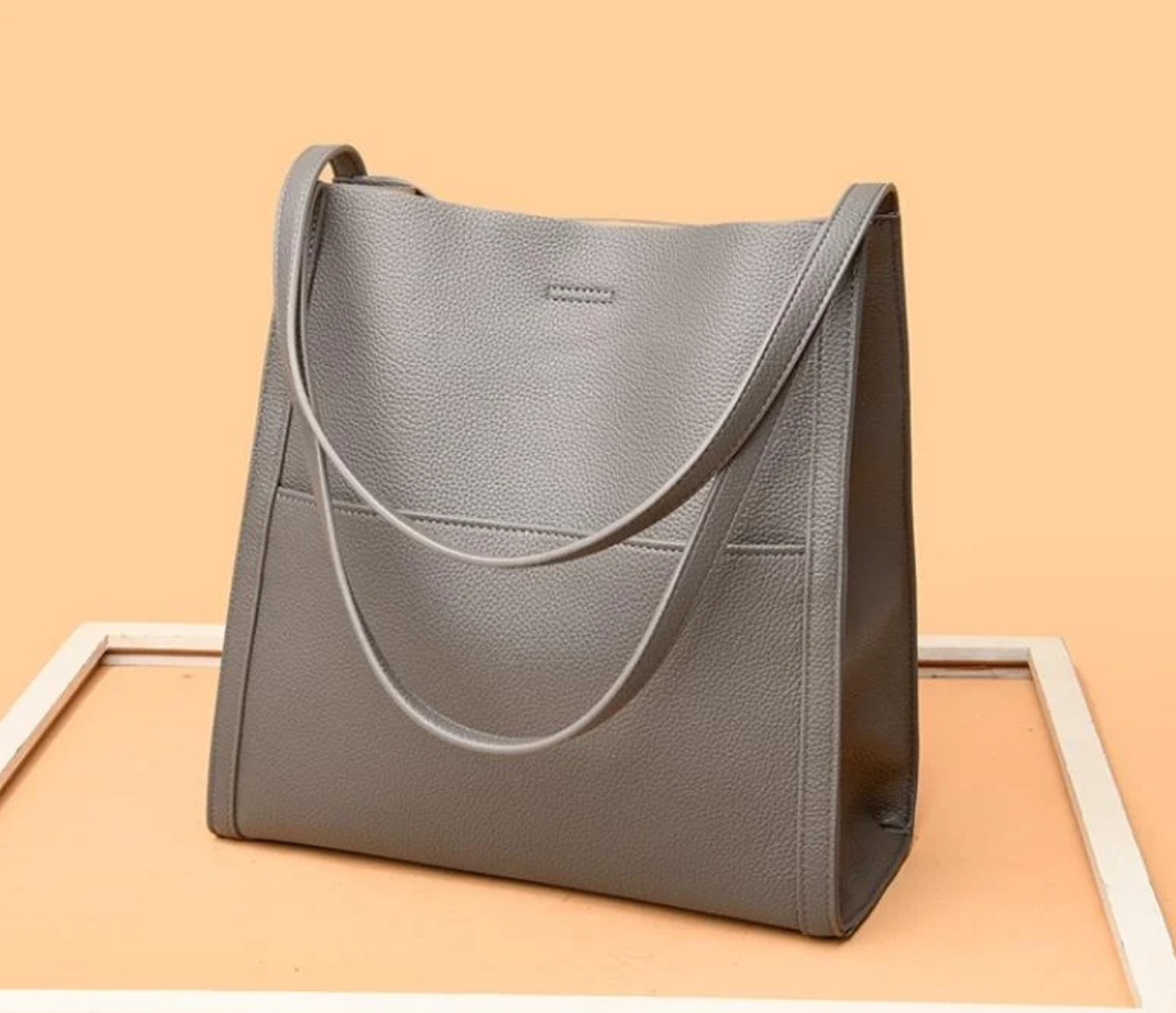 Gray tote bag with textured leather close-up view