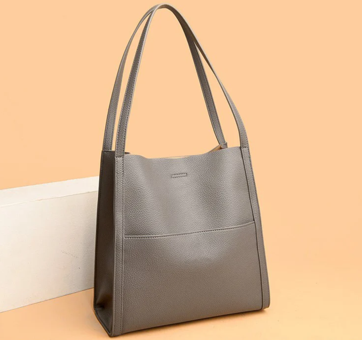 Gray tote bag with textured leather side view