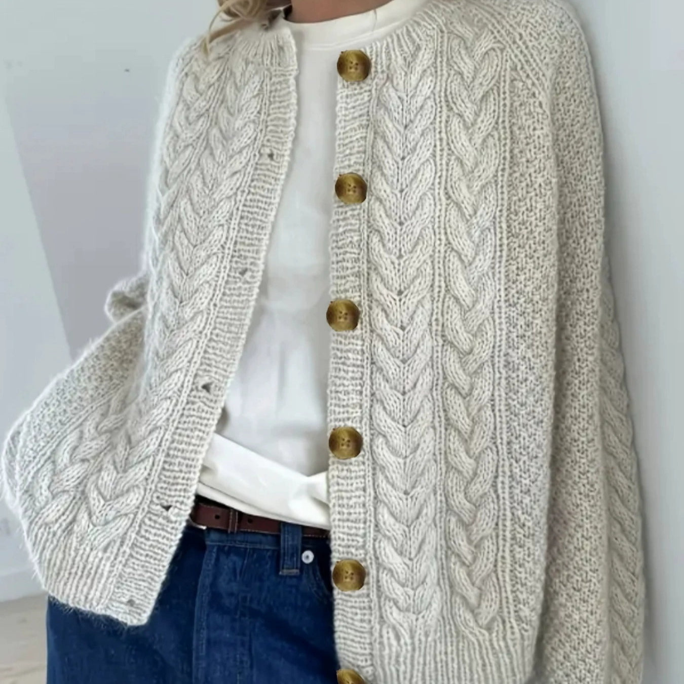 Cream cable knit cardigan button detail close-up