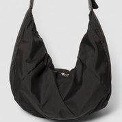 Black shoulder bag with adjustable strap, close-up front view