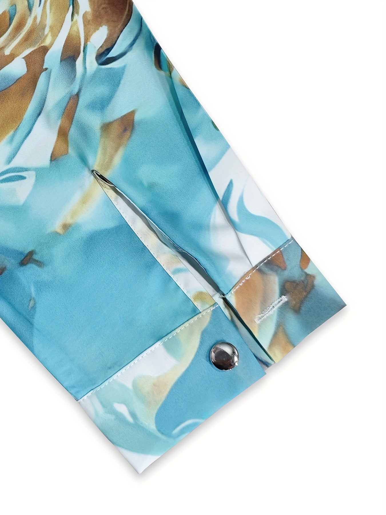 Silk blouse with abstract marbled print, close-up of cuff