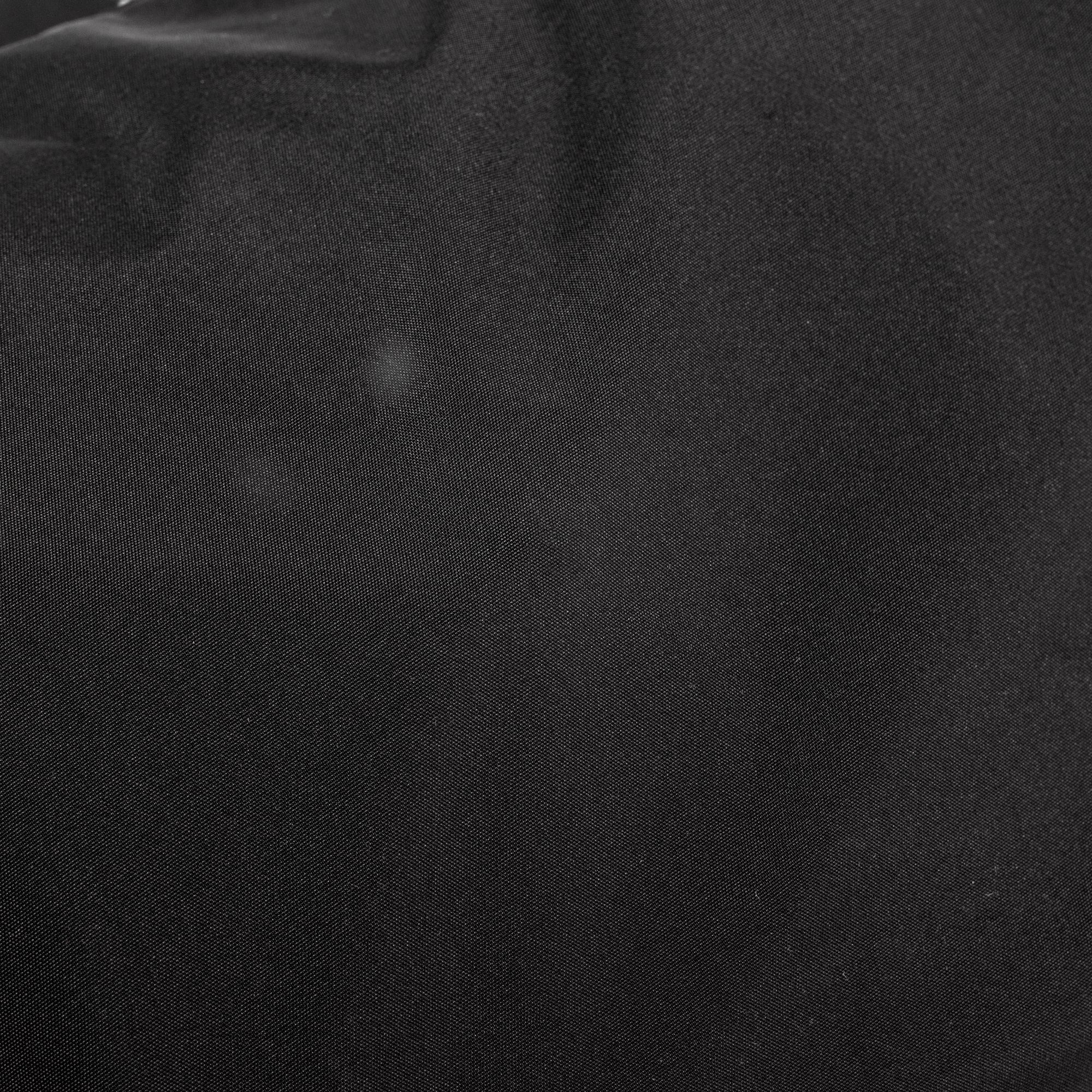 Black shoulder bag fabric texture, close-up detail