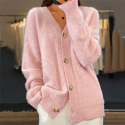 Pink knitted cardigan with gold buttons close-up