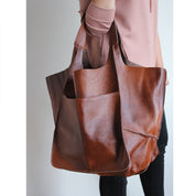 Brown slouchy tote with large exterior pockets, front view