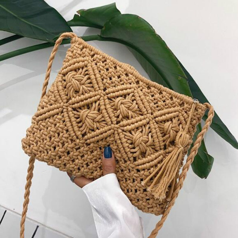 Beige macramé crossbody bag held by hand