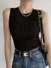 Black ribbed tank top with denim pants and belt side view