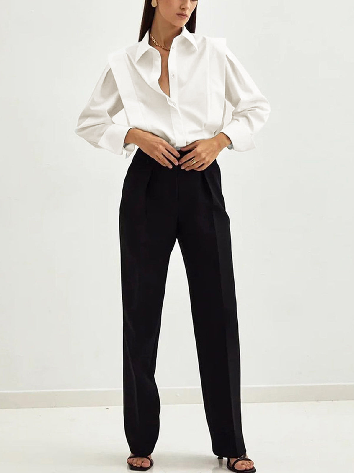 White blouse with black pants and belt full body view