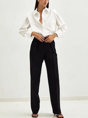 White blouse with black pants and belt full body view