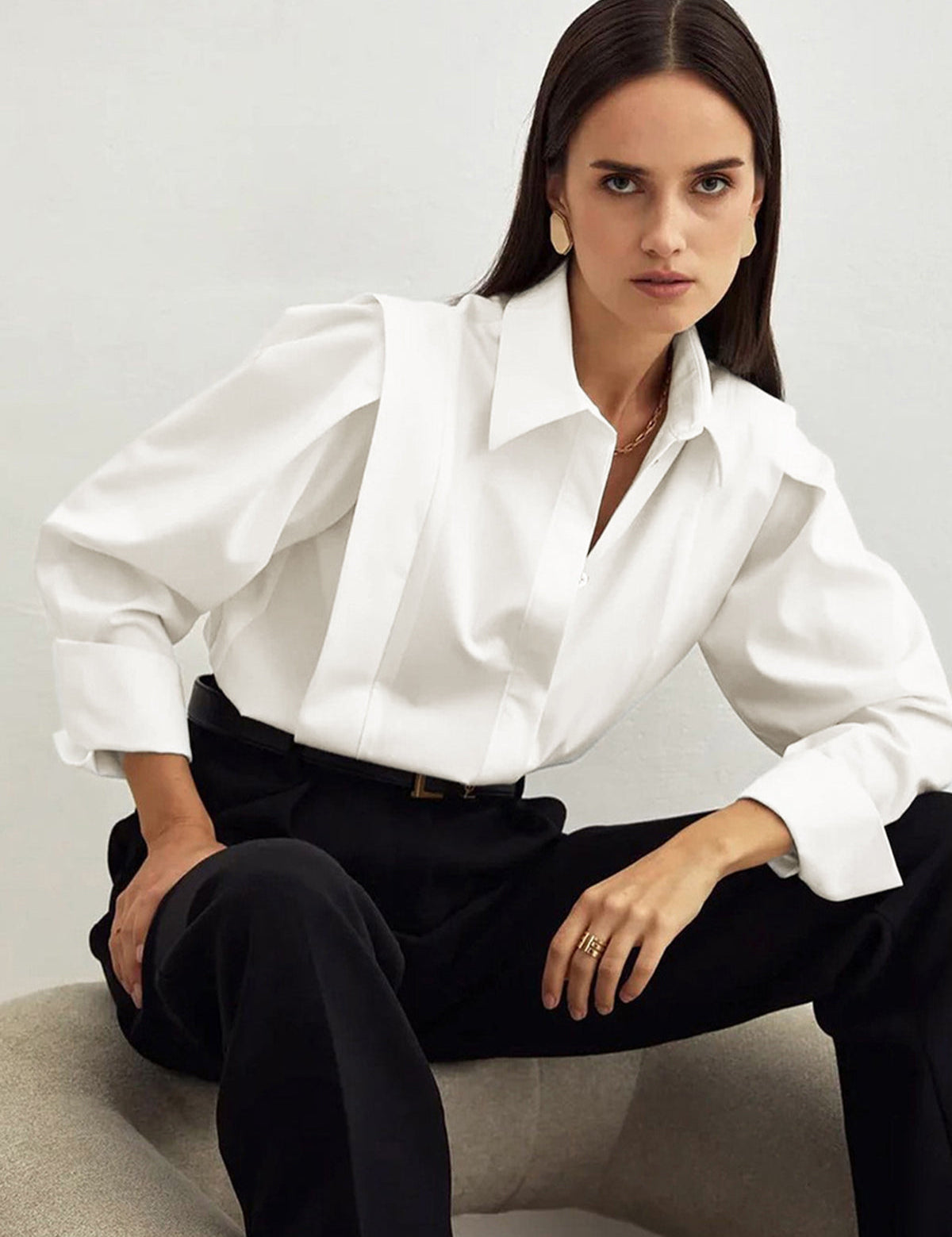 White blouse with puff sleeves and black pants front view