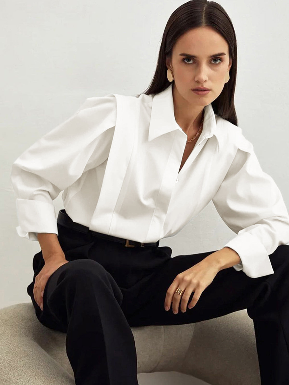 White blouse with puff sleeves and black pants front view