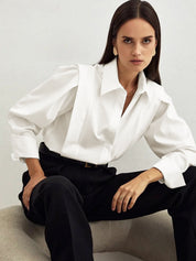 White blouse with puff sleeves and black pants front view