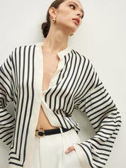 Striped blouse with band collar and white pants close-up front view
