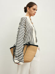 Striped blouse with band collar and white pants angled side view