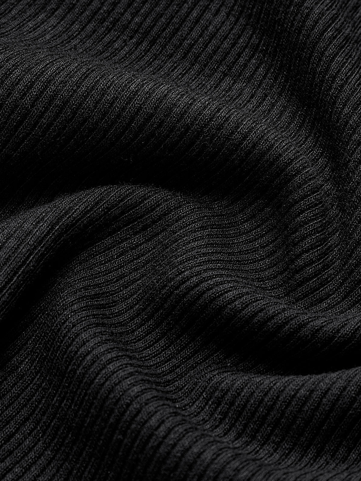 Zwarte trui met rimpeltextuur detailopname