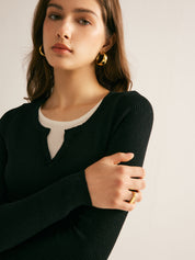 Dames trui zwart gebreid met witte ondertrui detail shot