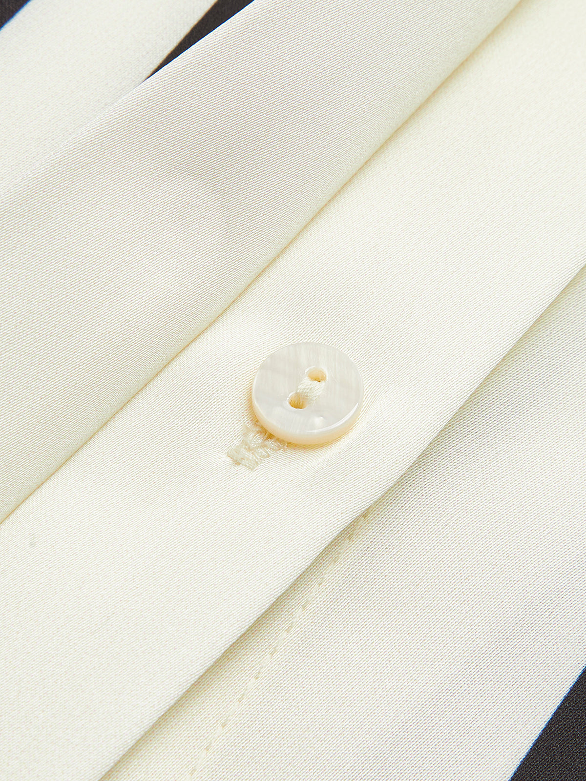 Striped blouse with band collar close-up button detail
