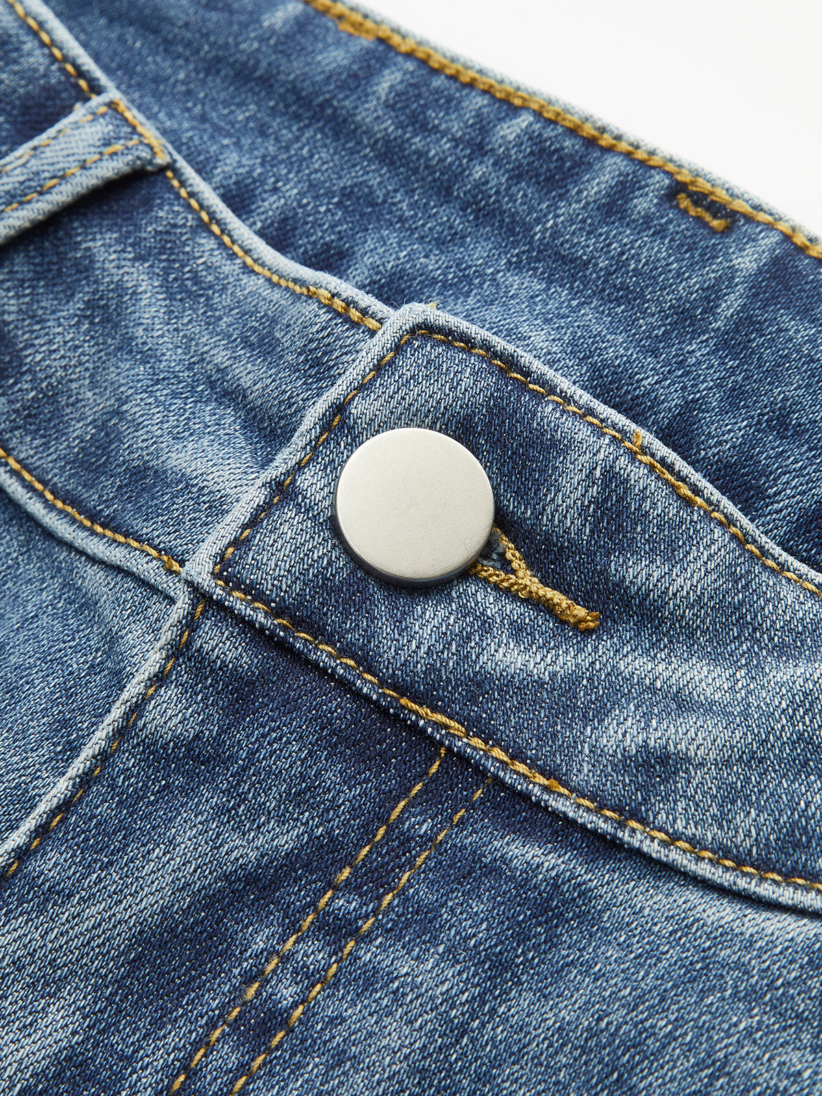 Flared jeans light blue button detail close-up