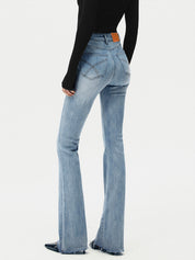 Flared jeans light blue back view with heels