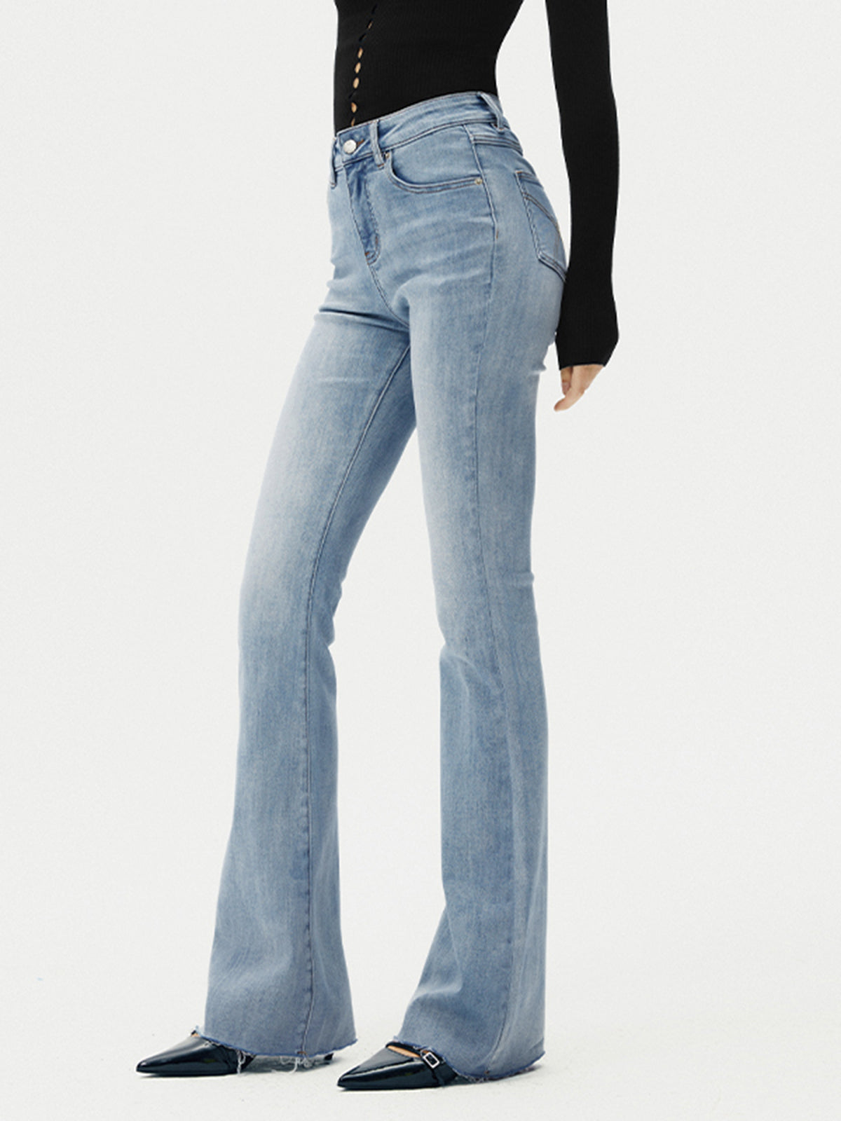 Flared jeans light blue side view with heels