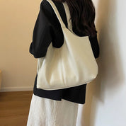 Cream textured shoulder tote worn by model