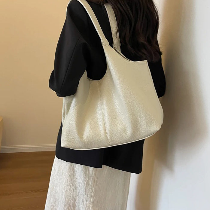 Cream textured shoulder tote worn by model