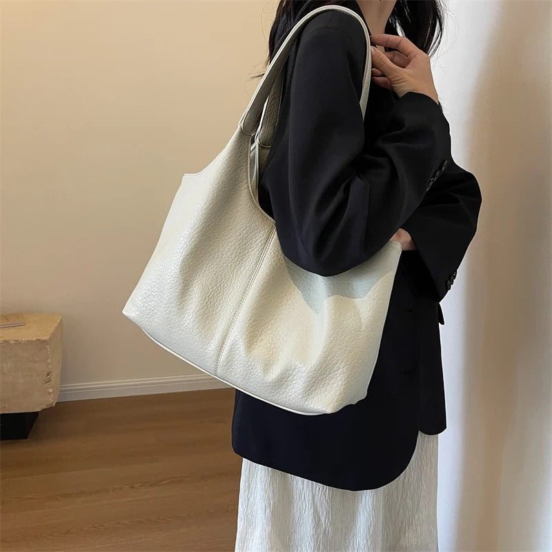 Cream textured shoulder tote model holding