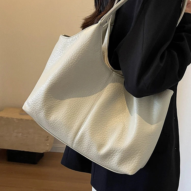 Cream textured shoulder tote model carrying