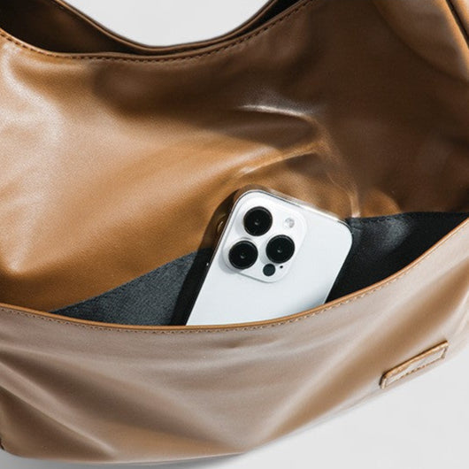 Tan leather slouchy shoulder bag with phone inside